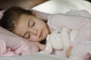 child-sleeping-with-stuffed-animal